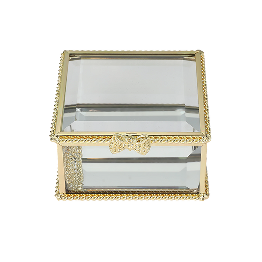 Glass jewelry box with gold decorative frame on a white background