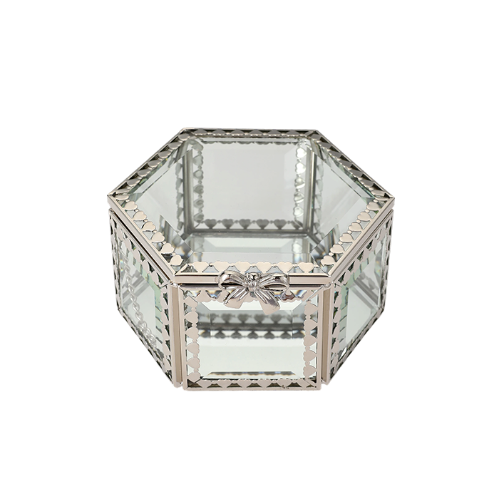 Hexagonal glass box with decorative metal frame on a white background