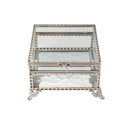 Decorative glass box with metal frame and bow on a white background