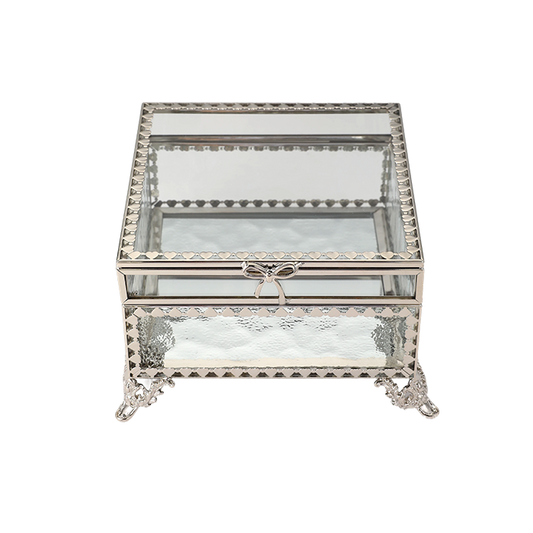 Decorative glass box with metal frame and bow on a white background