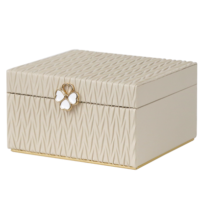 Beige jewelry box with butterfly emblem on a white background