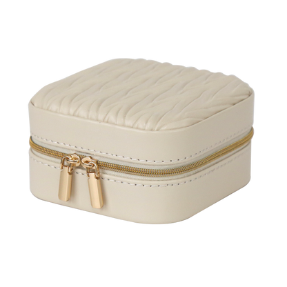 Beige jewelry box with gold zipper on a white background