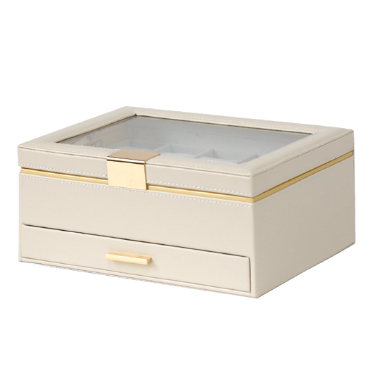 Beige jewelry box with a glass top and gold accents on a white background