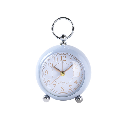 Small round clock with a keychain on a white background