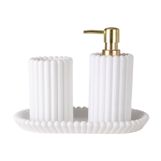 White textured soap dish with gold pump on a white background