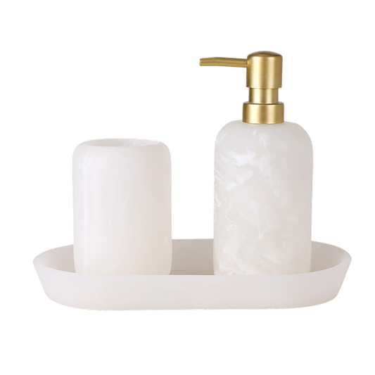 White marble soap dispenser with gold pump and matching tray on a white background