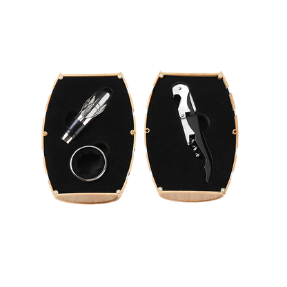 Set of wine tools including a bottle opener and corkscrew in a black and gold case on a white background.