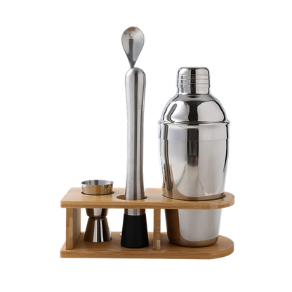 Set of cocktail-making tools including a shaker, jigger, and spoon on a wooden stand with a white background.