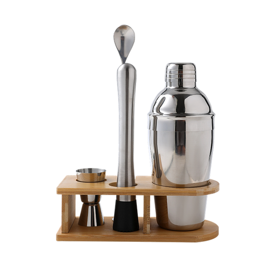 Set of cocktail-making tools including a shaker, jigger, and spoon on a wooden stand with a white background.